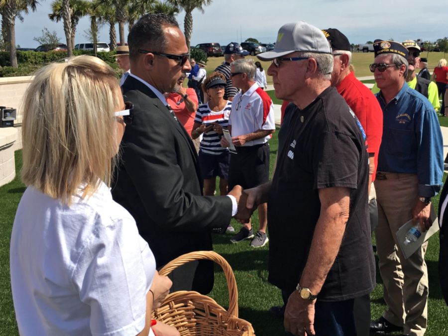 Fred shakes hands with a veteran