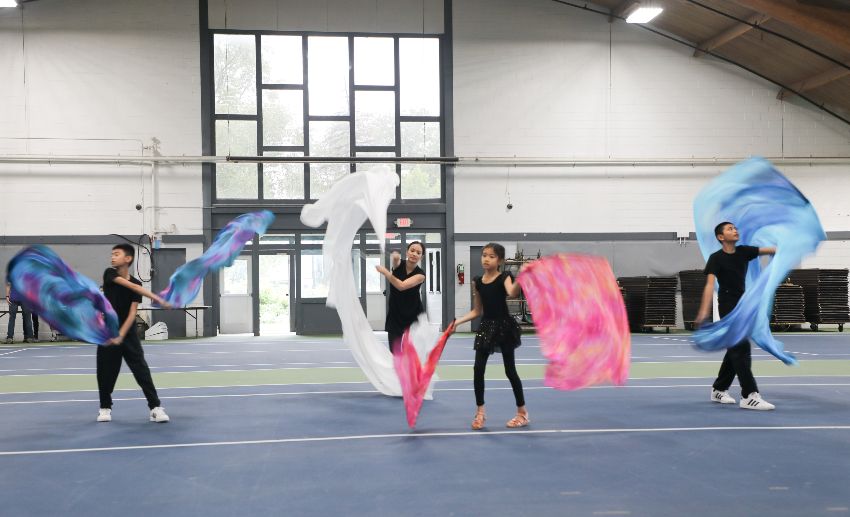 Four children perform an interpretative dance